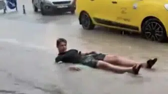 Fethiye'de sağanak yağış eğlenceye dönüştü: Sokakları deniz sanıp şişme yatakla yüzdüler