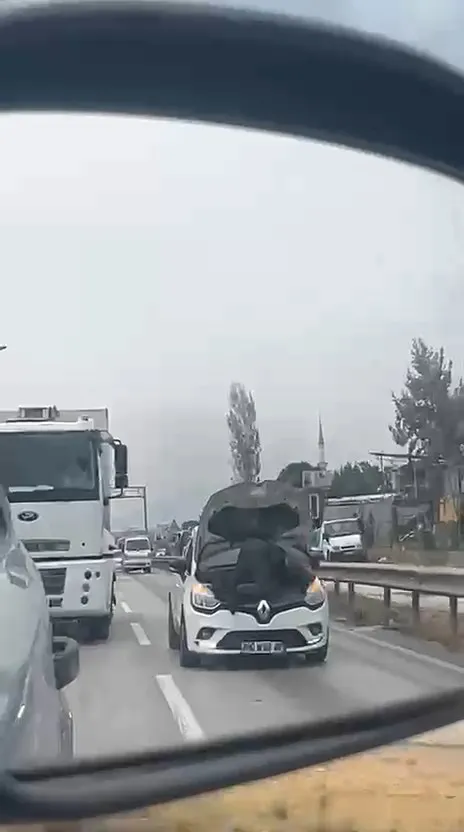 Bursa trafiğinde akıllara durgunluk veren görüntü: Kaputu açık otomobilin motorunda yolculuk yaptı